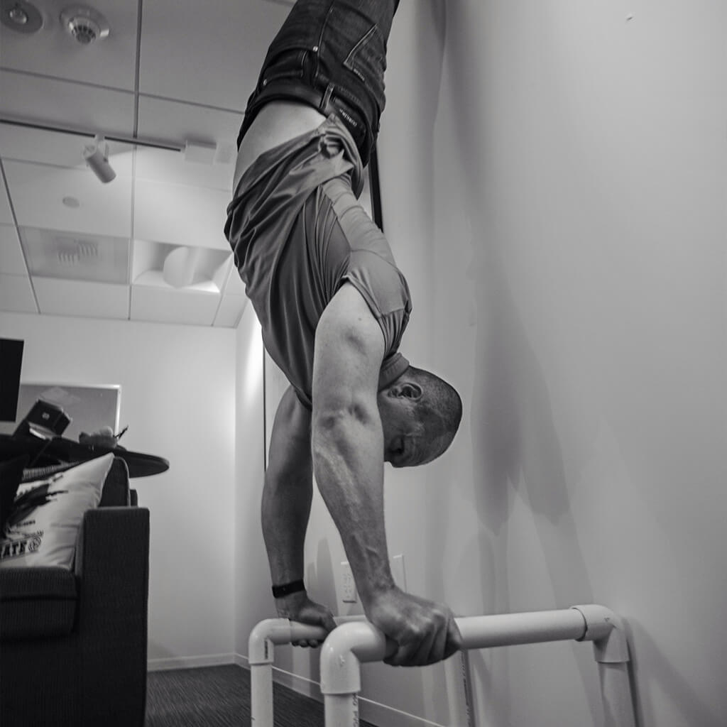 zack-office-hand-stand-square-bw